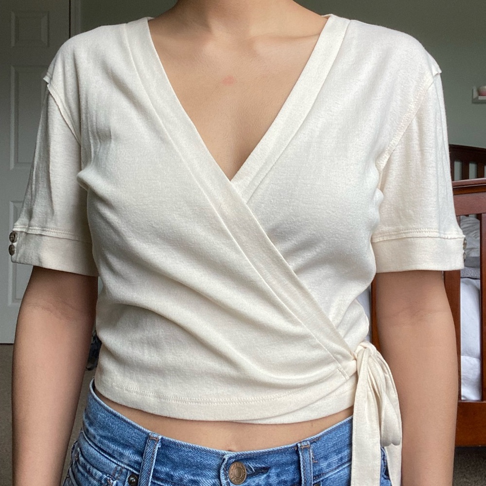 cream colored wrap shirt with tie on the side